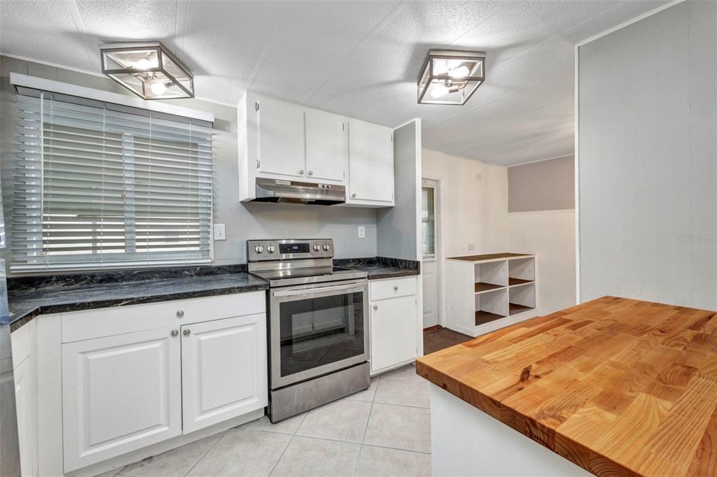 10100 Burnt Store Road, Unit 21 Punta Gorda, FL 33950 - Photo 5 of 61 a kitchen with stainless steel appliances granite countertop a sink and cabinets