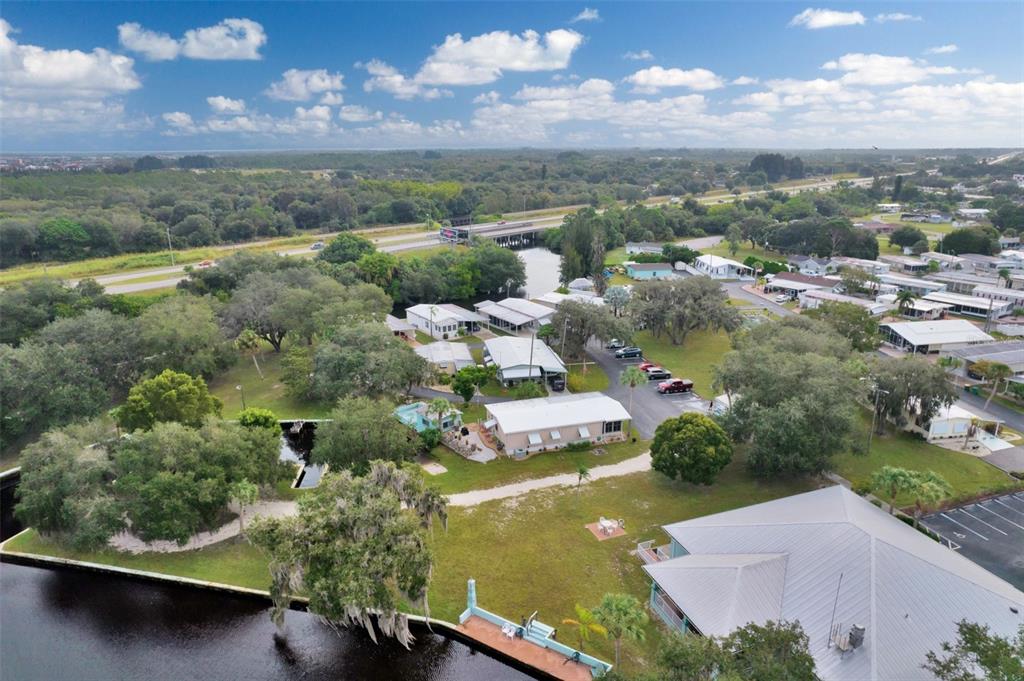 10100 Burnt Store Road, Unit 21 Punta Gorda, FL 33950 - Photo 60 of 61 an aerial view of residential houses with outdoor space and lake view