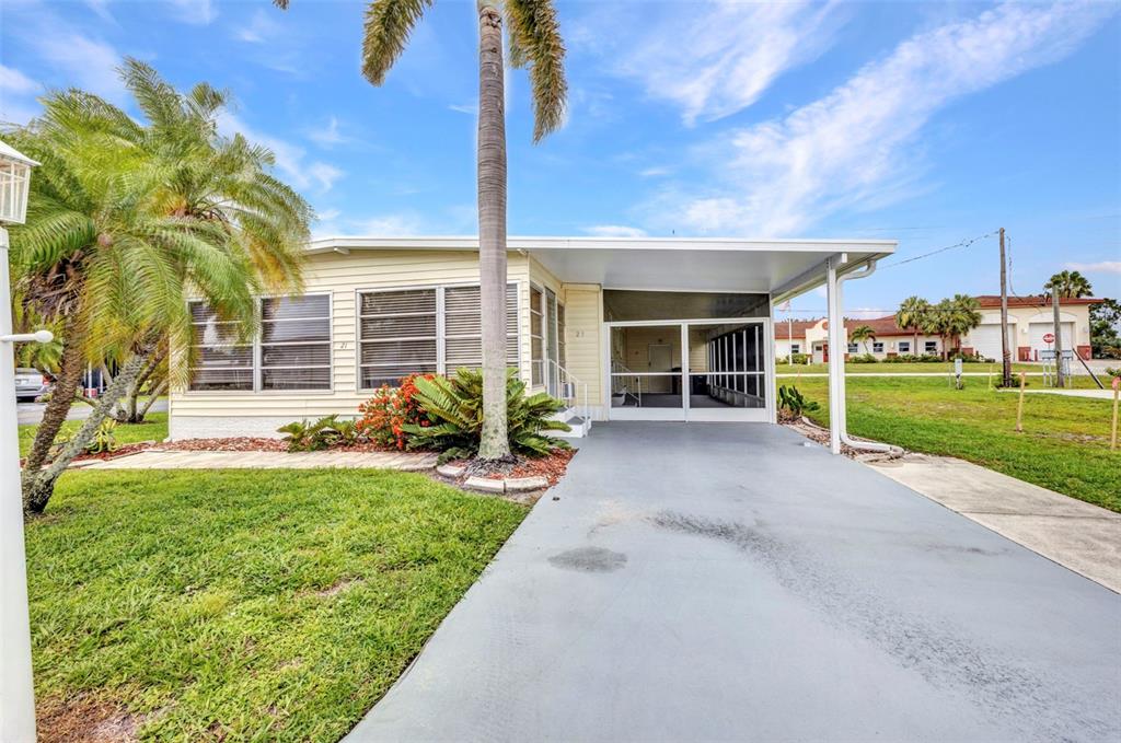 10100 Burnt Store Road, Unit 21 Punta Gorda, FL 33950 - Photo 7 of 61 a view of a house with backyard and porch