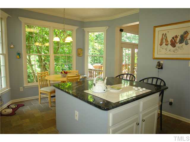 7012 Edgeview Court Raleigh, NC 27613 - Photo 12 of 25 a bathroom with a granite countertop sink and a mirror