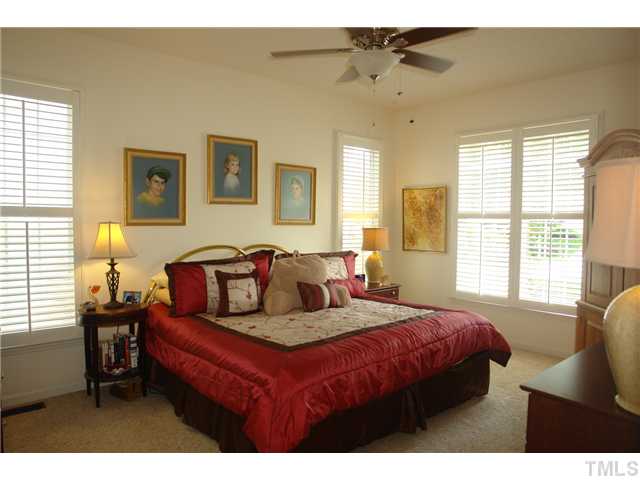 7012 Edgeview Court Raleigh, NC 27613 - Photo 13 of 25 a bedroom with a bed window and couch