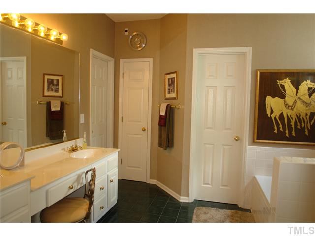 7012 Edgeview Court Raleigh, NC 27613 - Photo 14 of 25 a bathroom with a sink and a mirror