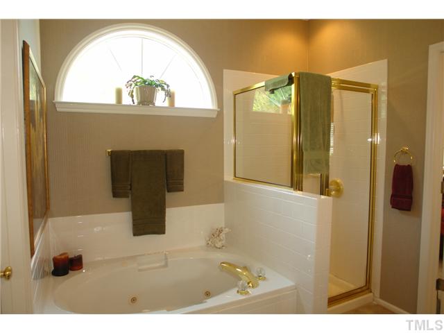 7012 Edgeview Court Raleigh, NC 27613 - Photo 15 of 25 a view of a bathroom with a glass door