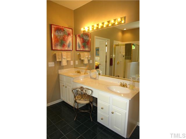 7012 Edgeview Court Raleigh, NC 27613 - Photo 16 of 25 a bathroom with a sink double vanity and a mirror
