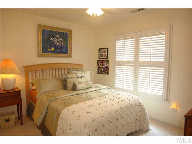 7012 Edgeview Court Raleigh, NC 27613 - Photo 17 of 25 a bedroom with a bed and a window