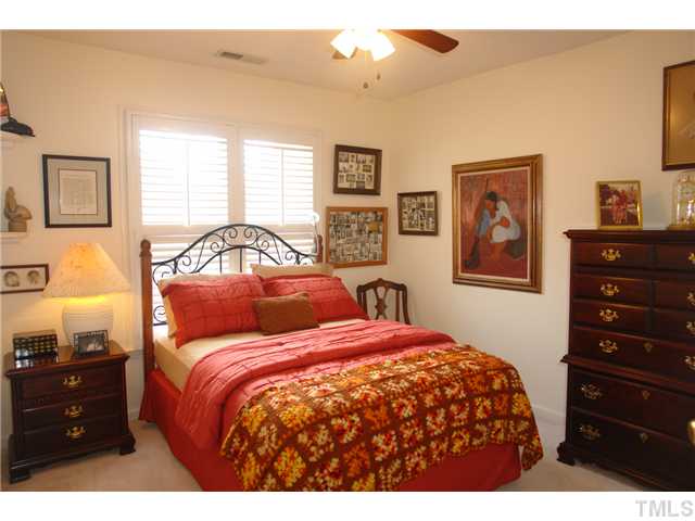 7012 Edgeview Court Raleigh, NC 27613 - Photo 18 of 25 a bedroom with a bed and a closet