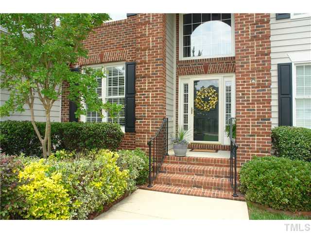 7012 Edgeview Court Raleigh, NC 27613 - Photo 2 of 25 a front view of a house with a garden
