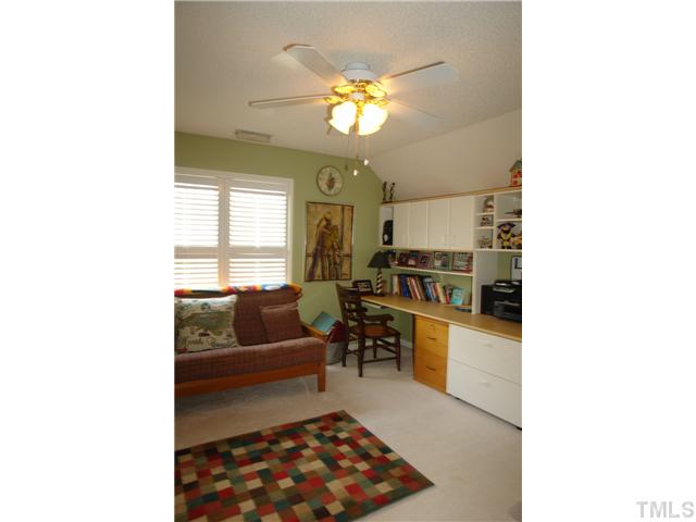 7012 Edgeview Court Raleigh, NC 27613 - Photo 21 of 25 a living room with furniture and a chandelier