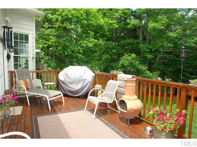 7012 Edgeview Court Raleigh, NC 27613 - Photo 24 of 25 a balcony with wooden floor and outdoor seating