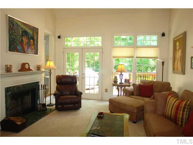 7012 Edgeview Court Raleigh, NC 27613 - Photo 7 of 25 a living room with furniture and a fireplace
