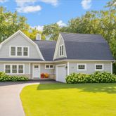 a front view of a house with swimming pool and porch