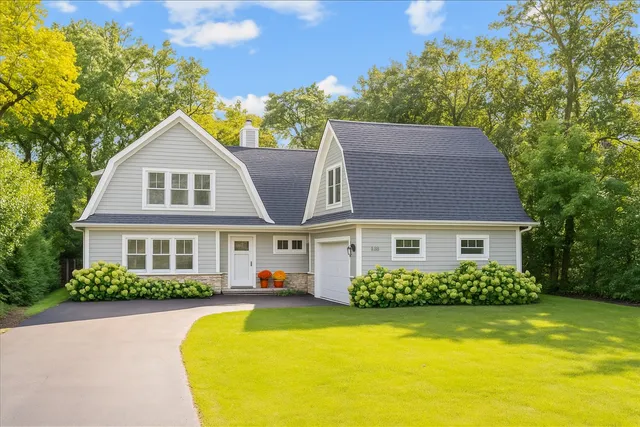 a front view of a house with swimming pool and porch