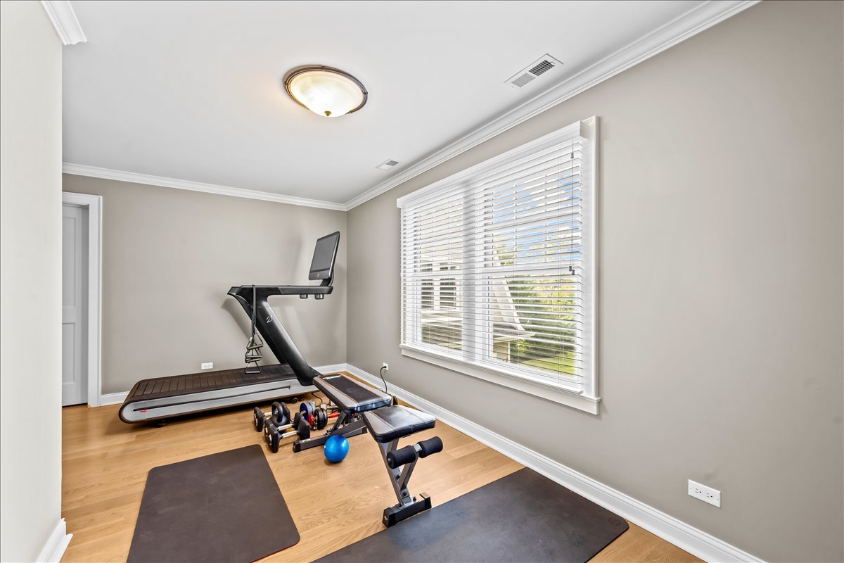 1625 Sunset Ridge Road Glenview, IL 60025 - Photo 36 of 49 a room with gym equipment and windows
