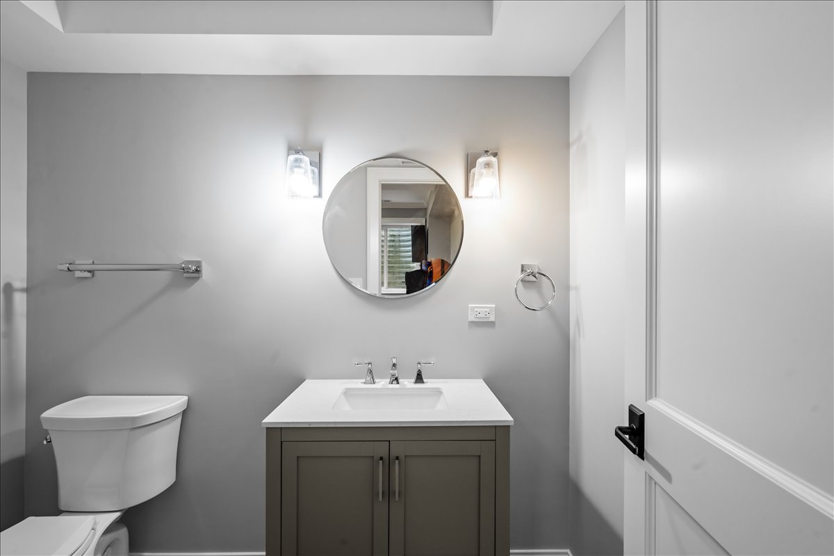 1625 Sunset Ridge Road Glenview, IL 60025 - Photo 45 of 49 a bathroom with a toilet sink and mirror