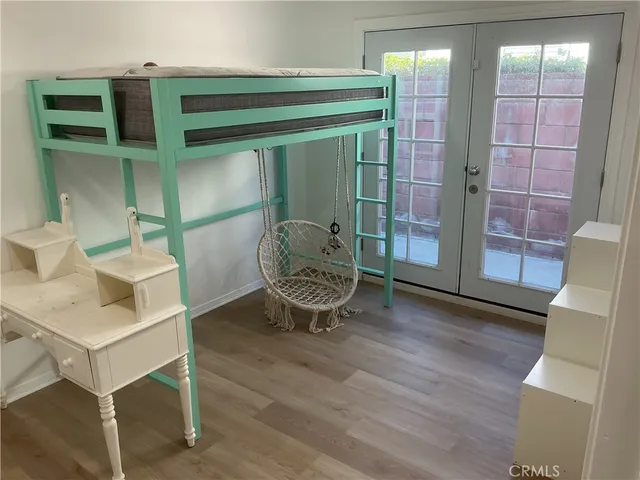 a living room with furniture a window and wooden floor