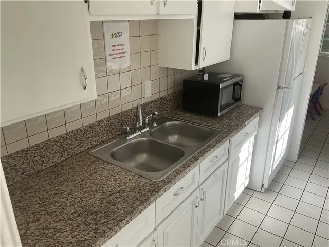 a kitchen with a sink and a mirror