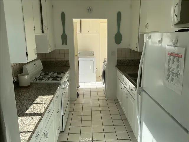 a bathroom with a granite countertop shower a mirror and a sink