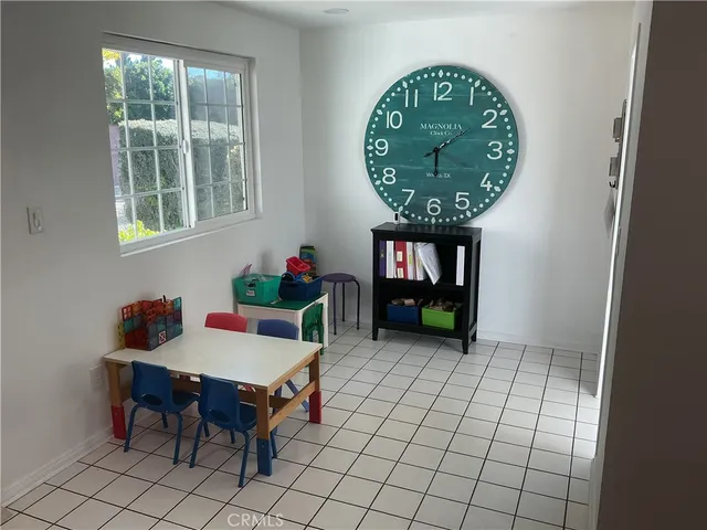 an entryway with a flower pot and a bookshelf