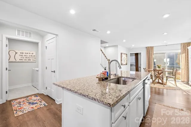 a kitchen with center island table and chairs