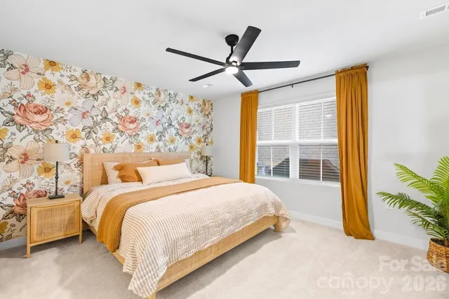 a bedroom with a bed and a large window