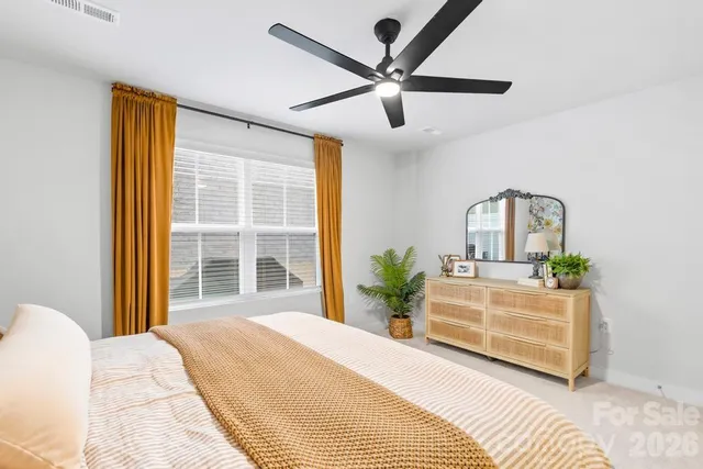 a bedroom with a large bed and a large window