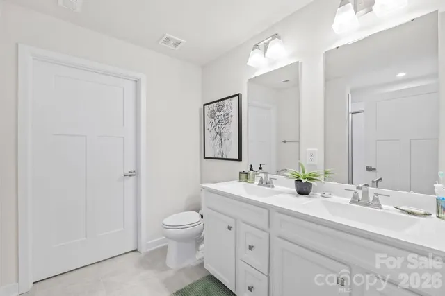 a bathroom with a double vanity sink and a mirror