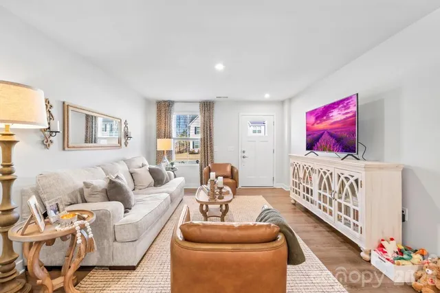 a living room with furniture and a baby crib