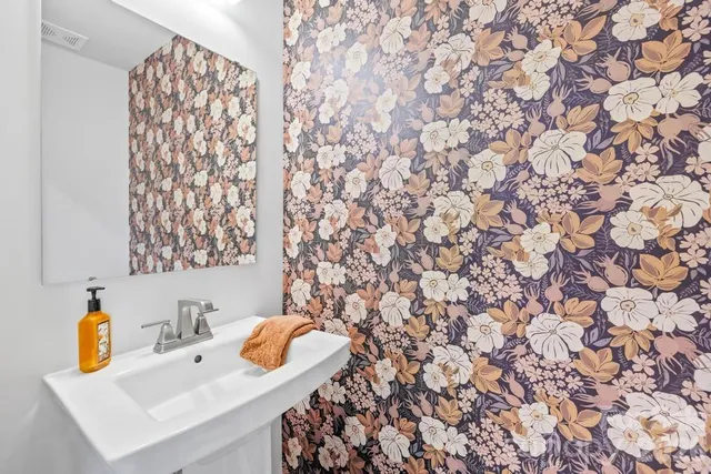 a bathroom with a sink toilet and a mirror