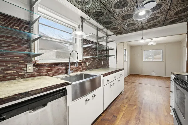 a large kitchen with a stove and a sink
