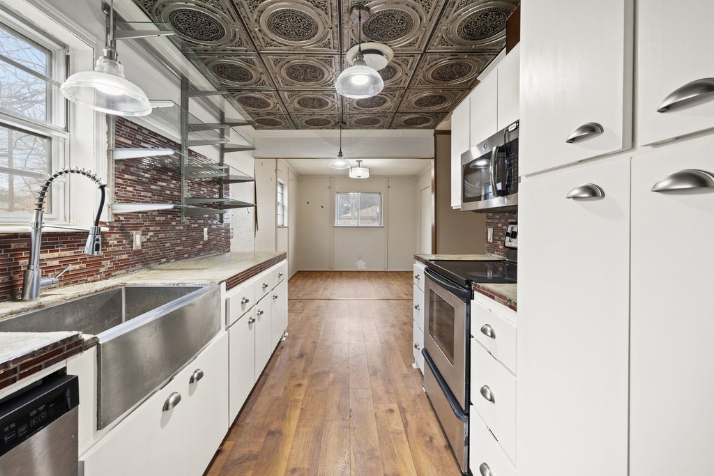 2204 Smith Avenue Taylor, TX 76574 - Photo 13 of 40 a view of a kitchen with a sink and cabinets