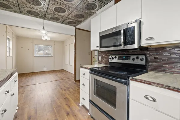 a kitchen with a stove and a microwave