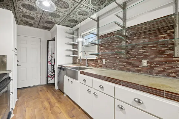 a kitchen with a sink and cabinets