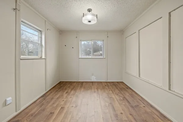 wooden floor in an empty room with a window