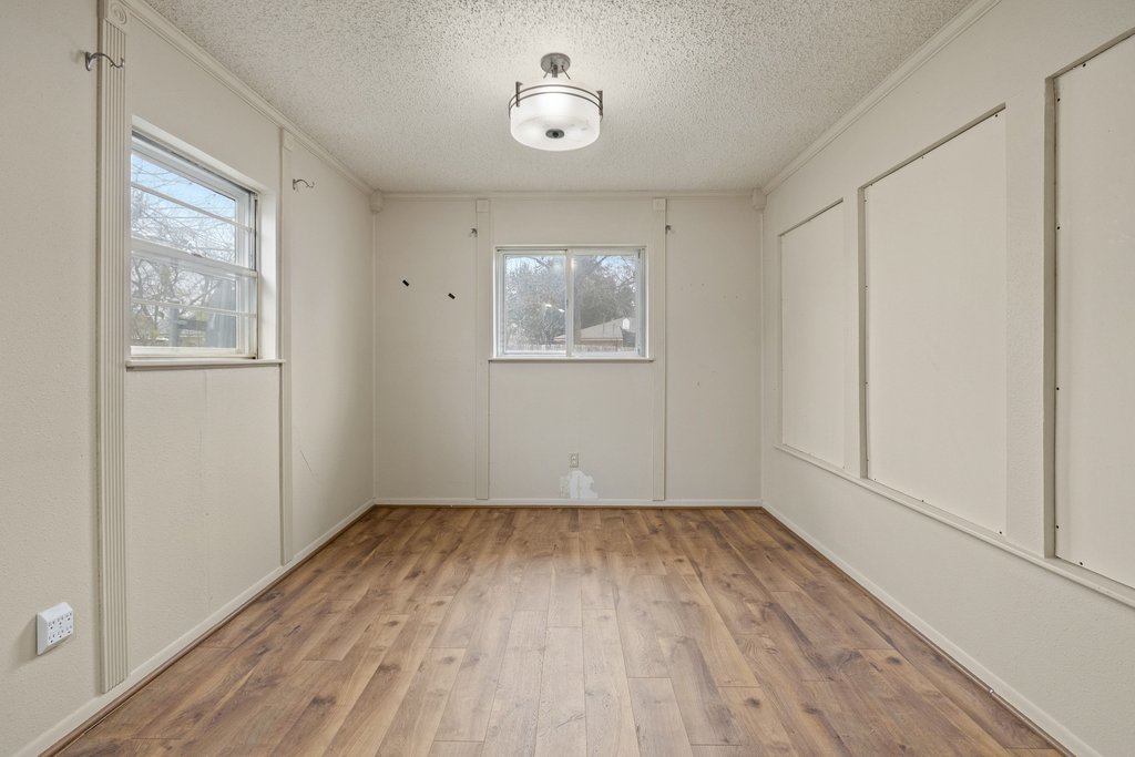 2204 Smith Avenue Taylor, TX 76574 - Photo 18 of 40 wooden floor in an empty room with a window