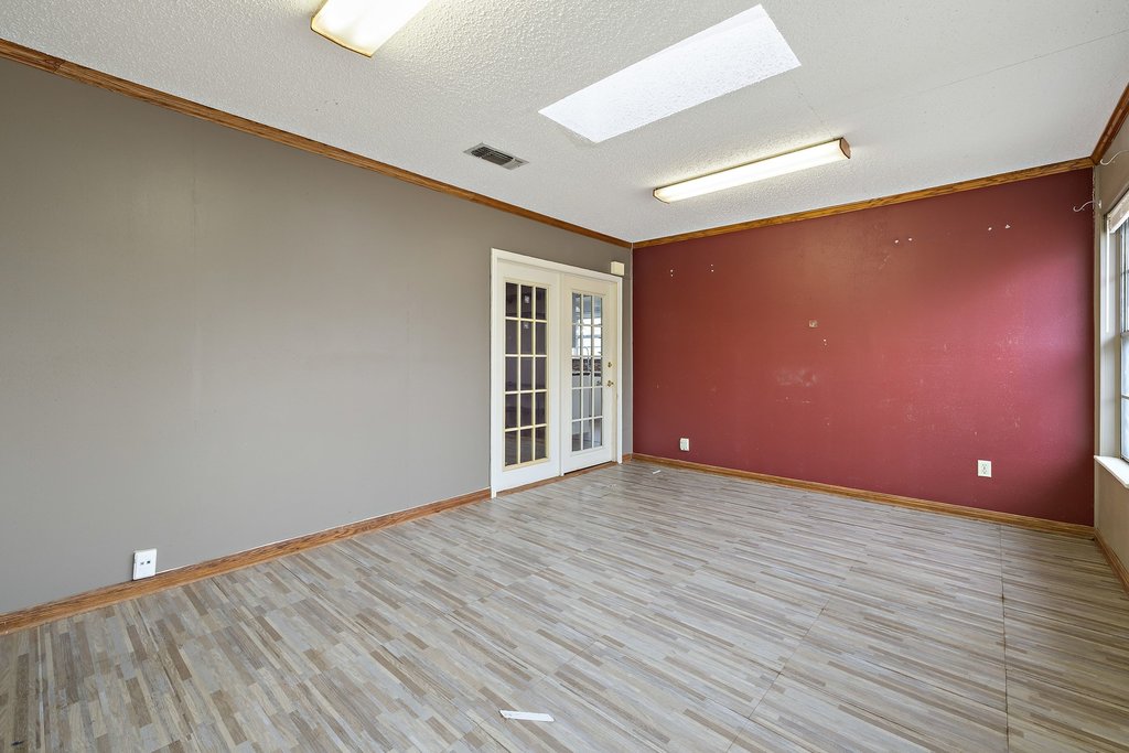 2204 Smith Avenue Taylor, TX 76574 - Photo 22 of 40 a view of an empty room with wooden floor and a window