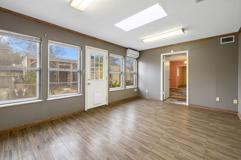 2204 Smith Avenue Taylor, TX 76574 - Photo 23 of 40 a view of an empty room with wooden floor and a window