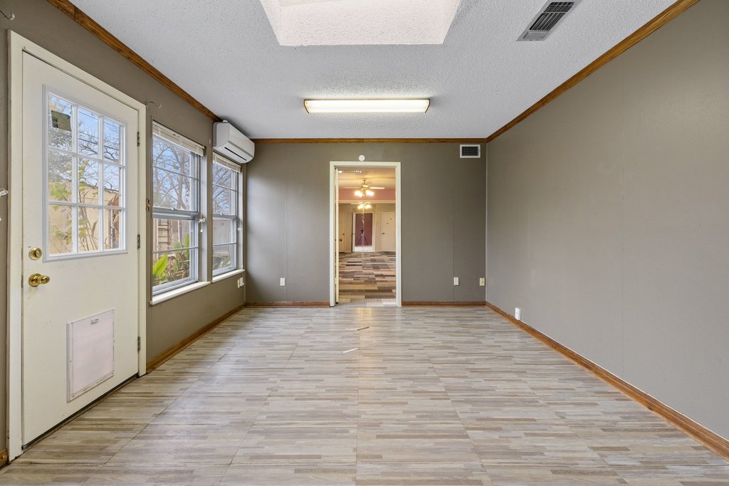 2204 Smith Avenue Taylor, TX 76574 - Photo 24 of 40 a view of an empty room with a window and wooden floor