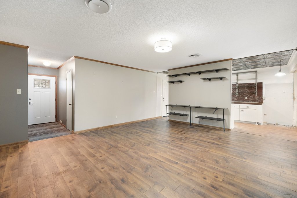 2204 Smith Avenue Taylor, TX 76574 - Photo 9 of 40 a view of a room with wooden floor and white walls