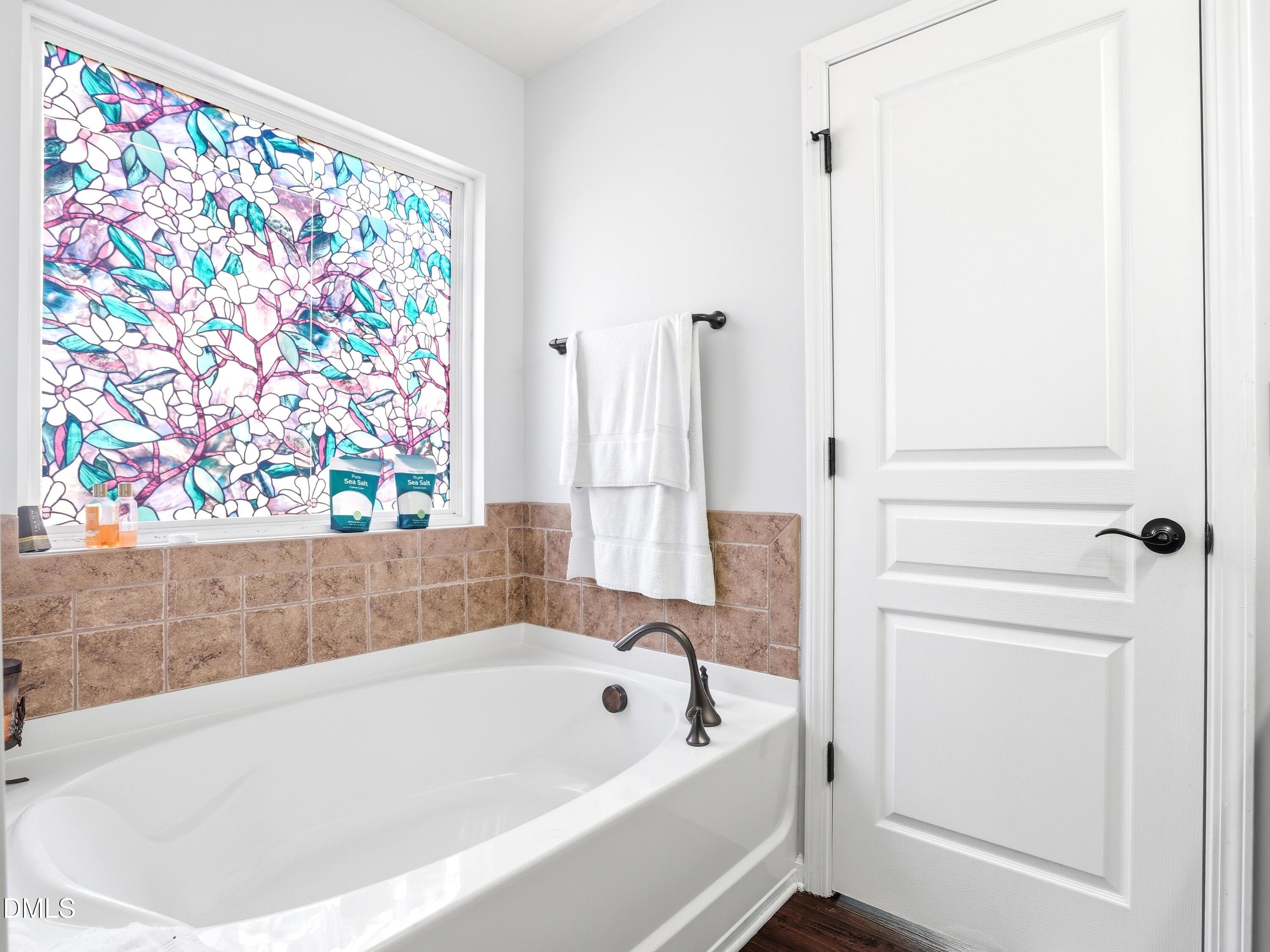 8128 Hovingham Way Raleigh, NC 27616 - Photo 18 of 40 a bathroom with a bathtub and a shower