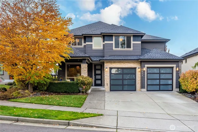 a front view of a house with a yard and garage