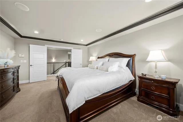 a bathroom with a double vanity sink a large mirror and a bathtub