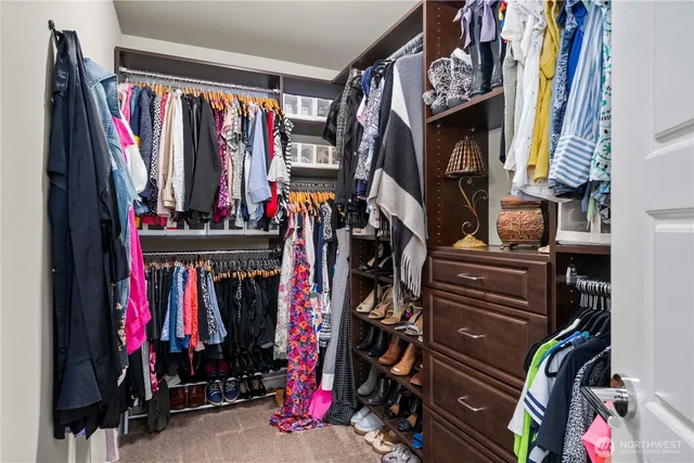 a view of a hallway with a livingroom and stairs