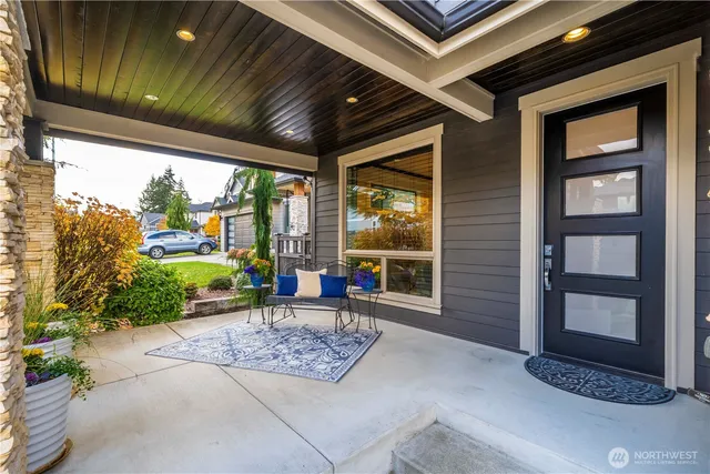 a view of a patio with a table and chairs and potted plants