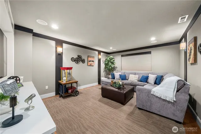 a living room with a flat screen tv a stove and a refrigerator