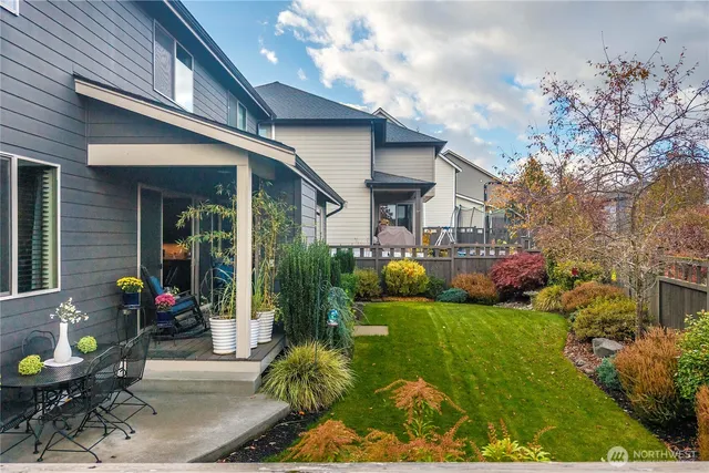 a front view of a house with a yard and plants