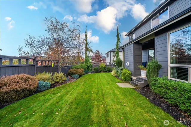 a view of a house with garden and a bench