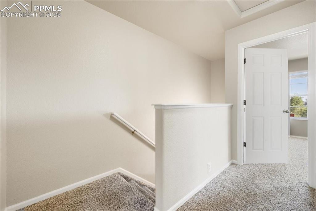 2740 Stonecrop Ridge Grove Colorado Springs, CO 80910 - Photo 19 of 42 Staircase featuring carpet and baseboards