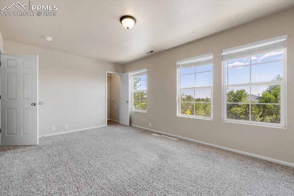 2740 Stonecrop Ridge Grove Colorado Springs, CO 80910 - Photo 21 of 42 Unfurnished bedroom featuring baseboards and carpet