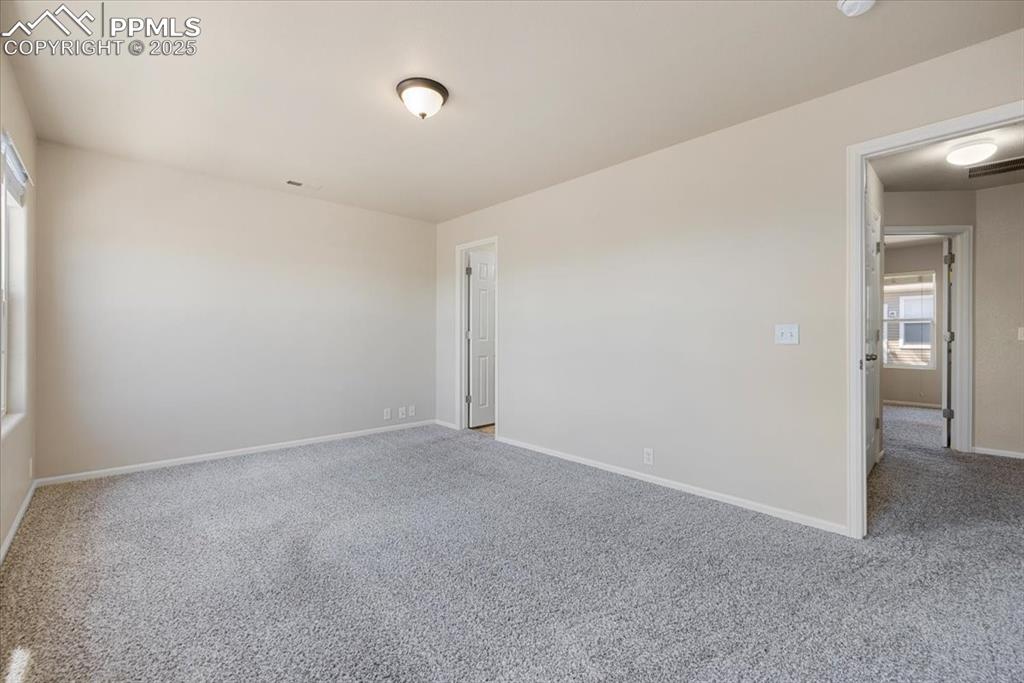 2740 Stonecrop Ridge Grove Colorado Springs, CO 80910 - Photo 22 of 42 Empty room featuring carpet flooring and baseboards