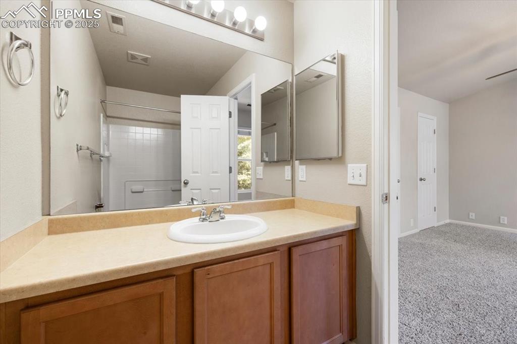 2740 Stonecrop Ridge Grove Colorado Springs, CO 80910 - Photo 32 of 42 Bathroom with vanity and baseboards